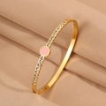 Elegant gold titanium steel bracelet with a pink enamel centerpiece and crystal accents - Pink Round Rhinestone Bangle