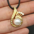 Macro view of a gold-plated spiral peacock wing pendant with pearl and sparkling zircons - White Artificial Pearl Necklace (With Black Cord) / 14x24mm / White