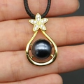 Detailed close-up of water drop pearl pendant necklace with gold floral diamond setting - Necklace (With Black Cord) / Black (Black Pearl Necklace)