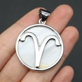 Macro detail of Aries zodiac pendant with white mother of pearl and silver frame - 32x37mm / Aries