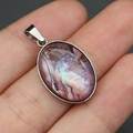 Macro detail of oval abalone shell pendant with silver frame held by hand for scale - Pendant Only (Without Chain) / Purple Pink Iridescent Pendant (No. 3)