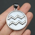 Detail of Aquarius shell pendant with silver frame held by hand for scale and texture - 32x37mm / Aquarius