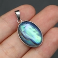 Detailed view of an oval abalone shell pendant with rainbow sheen and silver metal bezel - Pendant Only (Without Chain) / Pendant Only (Without Chain) - Abalone Shell