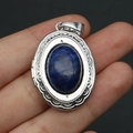 Close-up of vintage oval silver locket pendant with deep blue gemstone and engraved metal - Pendant Only (No Chain) / Lapis Lazuli Pendant