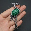 Detailed view of crane brooch with silver feather texture and green malachite stone - 43x79mm / Malachite