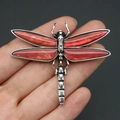 Detailed close-up of a vintage dragonfly brooch with red shell wings and silver metal - Wine Red (No. 4)