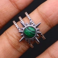 Macro shot of silver sunburst ring with green malachite stone and triple-layered band - Malachite
