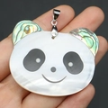 Detailed close-up of a panda pendant crafted from white shell and iridescent abalone shell - Panda Style