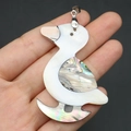 Detail of handmade duck pendant crafted from natural mother of pearl and abalone shell - Duck Style