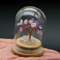 Macro detail of amethyst and rose quartz life tree inside a clear glass dome - Pink Amethyst
