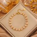 Detailed close-up of a gold stainless steel bracelet with pink cubic zirconia stones - Gold Square Pink Zirconia Bracelet