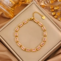 Close-up of gold stainless steel bracelet featuring rectangular pink cubic zirconia stones - Gold Rectangle Pink Zirconia Bracelet