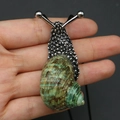 Silver snail pendant with natural green shell and black cord, handheld for size reference - Green Snail Necklace / 20-60mm, 11-17g / Silver