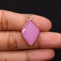 Detail showing hand holding a diamond-shaped pink stone pendant with gold edge - 15x25mm 3g/Item / US 1