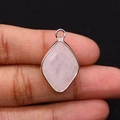 Macro shot of a faceted rose quartz pendant with gold plated metal rim and loop - 15x25mm 3g/Item / Rose Quartz