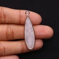 Detail of hand holding a natural rose quartz teardrop pendant with gold-plated metal edging - White Crystal