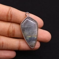 Macro detail of natural labradorite stone pendant with gold edge and colorful iridescence - Labradorite