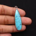 Detail of teardrop turquoise pendant with rose gold plating held by hand - Blue Turquoise