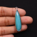 Detailed close-up of a blue teardrop natural stone pendant with a gold electroplated rim - Sky Blue Texture (No. 2)