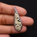 Macro shot of silver-edged teardrop Dalmatian Jasper stone pendant with black speckles - 12x38mm 4g/pc / Dalmatian Jasper
