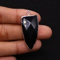 Macro view of faceted black agate arrowhead pendant with gold-plated metal edging - 16x38mm / Black Agate