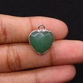 Pendentif cœur doré avec pierre aventurine verte tenu entre les doigts pour échelle - Aventurine Verte