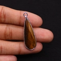 Waterdrop-shaped tiger eye stone pendant with silver metallic trim held by hand - 12x38mm 4g/pc / Tiger's Eye