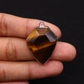 Polished tiger eye stone pendant in shield shape with golden plated faceted edge - 22x30mm / Tiger's Eye