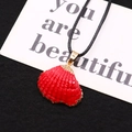 Detailed view of red scallop shell pendant with gold plated edges on black cord - Red Lacquered Style (No. 9)
