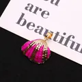 Macro detail of a pink enamel shell pendant with a gold-plated metallic edge finish - Bright Pink Enamel