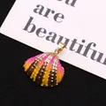 Macro detail of natural shell pendant with gold electroplated edge and colorful gradient - Pink-Yellow Gradient