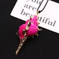 Macro detail of natural pink shell pendant with gold-plated edges on black woven cord - Conch Pendant With Cord / Rose Red (No. 4)