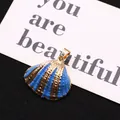 Vibrant blue shell charm with gold-plated trim and elegant radiating textures - Blue With Gold Edge