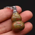 Macro shot of unakite crystal perfume bottle pendant with a stainless steel chain - 18x35mm / Unakite