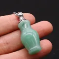 Macro shot of a mini green jade perfume bottle pendant with silver chain detail - Green Aventurine