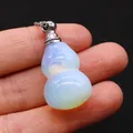 Macro detail of a crystal gourd perfume bottle pendant with iridescent glow on a chain - 18x35mm / Opal