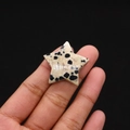 Close-up of star-shaped Dalmatian Jasper stone with natural black spots held in hand - 30mm (Thickness 8mm) / Dalmatian Jasper