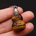 Tiger Eye stone gourd-shaped perfume bottle pendant with silver chain held in fingers - 18x35mm / Tiger's Eye