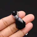 Faceted black natural stone essential oil bottle necklace with silver chain held in hand - 19x35mm / Black Agate