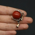 Detailed view of golden dragon claw pendant holding a round red stone for DIY jewelry - Red Jasper