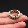 Polished Dalmatian Jasper stone ring with black spots on natural beige background - Dalmatian Jasper