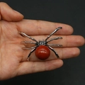 Macro view of spider pendant featuring a large red agate stone set in silver metal - 34x47mm, 14g / Red Jasper