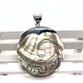 Close-up of black mother-of-pearl shell pendant with wave hollow carving and silver bail - Style 6 Hollow Carved Crescent