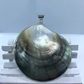 Macro detail of round black shell pendant with iridescent luster and silver bail - Style 7 Large Round Shell
