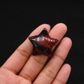 Polished star-shaped mahogany obsidian gemstone held in hand for jewelry making - 30mm (Thickness 8mm) / Swan Stone