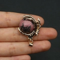 Golden dragon claw pendant featuring a pink textured natural stone sphere and hook - Rhodonite with Black Lines