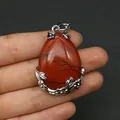 Roter Naturstein-Tropfenanhänger mit silbernen Blatt- und Blumendetails in der Hand - Roter Jaspis (Anhängerkette nicht enthalten) / 28x41mm