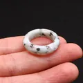 Natural spotted agate stone ring with black speckles worn on finger, polished finish - Azurite