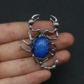 Silver scorpion pendant with oval blue tiger eye stone held in hand for jewelry DIY - No.3 (Blue Cat's Eye)