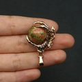 Golden dragon claw pendant featuring natural green and red stone with scaled texture finish - Unakite